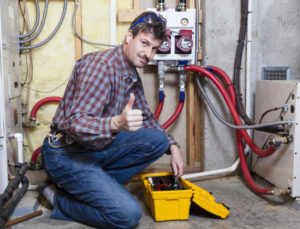 Technician Giving Thumbs Up Next To Furnace