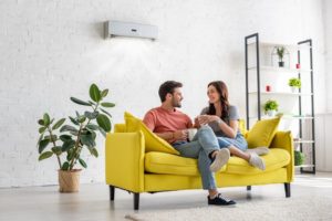 Couple Sitting On Couch In Living Room