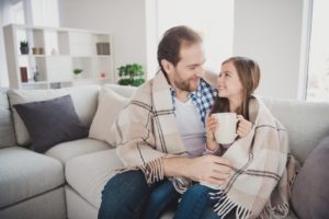 Dad And Daughter Wrapped In Blanket With Mug Of Hot Cocoa