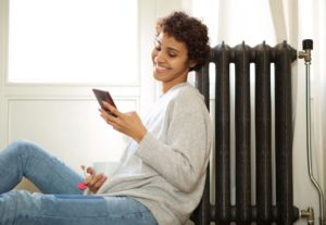 Happy Woman With Smart Thermostat